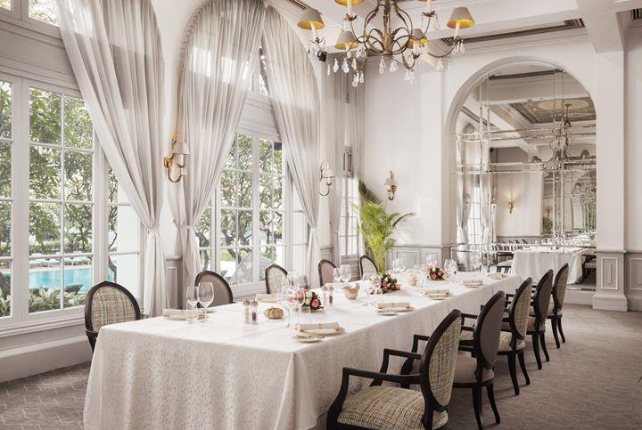 a long table with white tablecloths and chairs