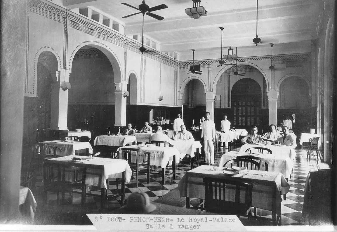 a group of people sitting at tables in a restaurant