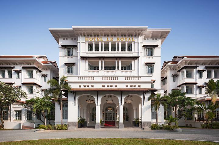 a white building with columns and a red carpet