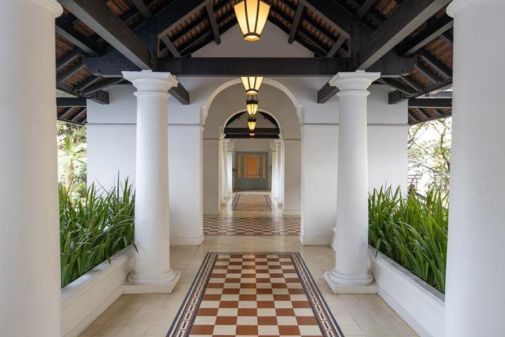 a white building with columns and a checkered floor