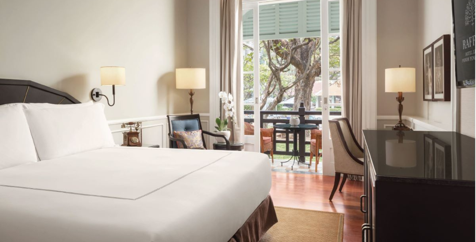 a room with a bed and chairs and a table