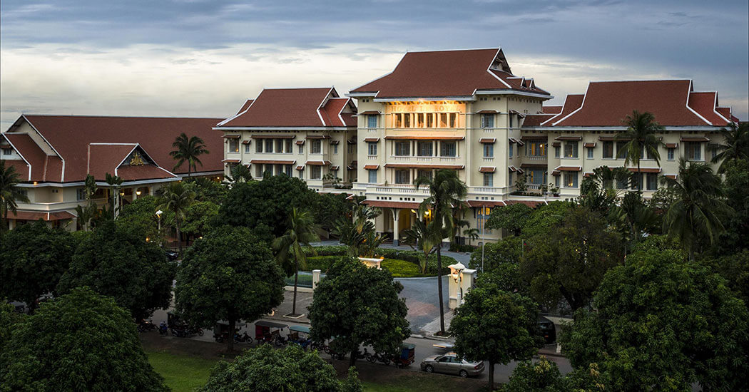 a large building with trees and cars