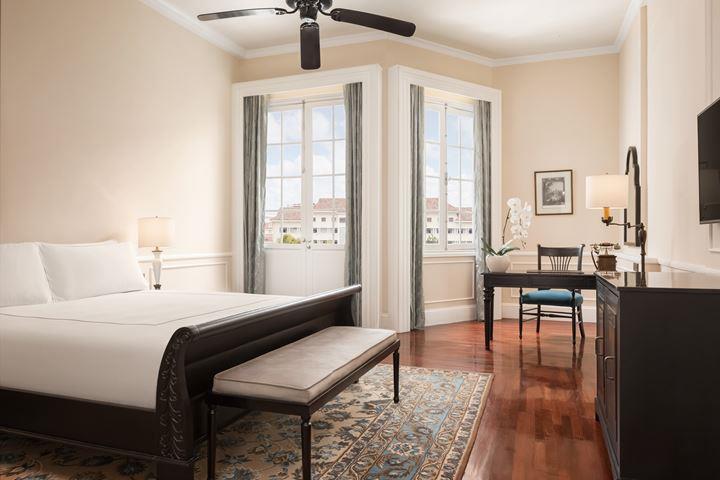 a bedroom with a bed and a desk