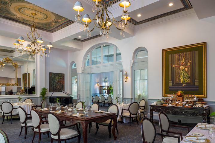a room with a piano and tables