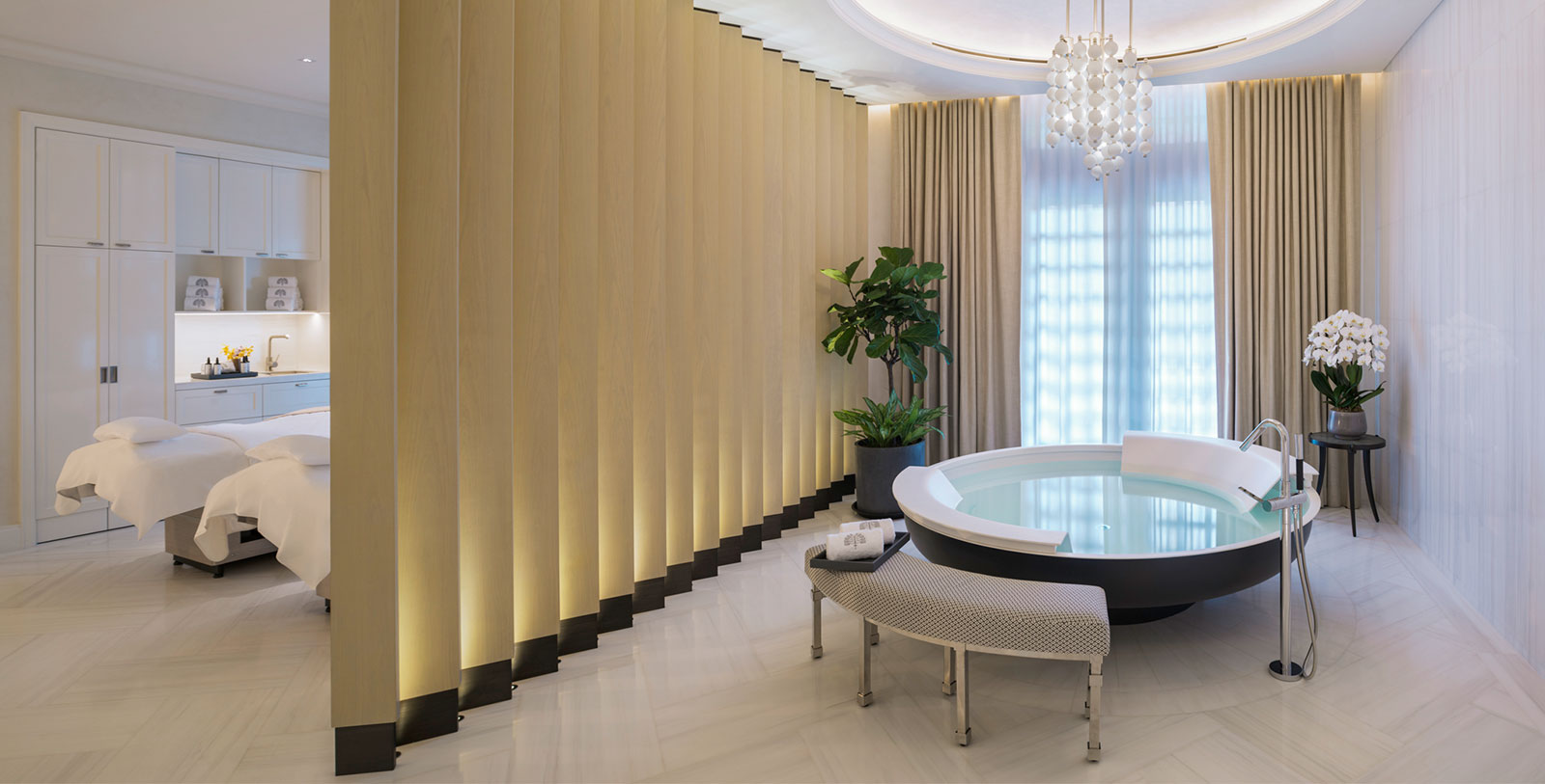 a room with a hot tub and a bench
