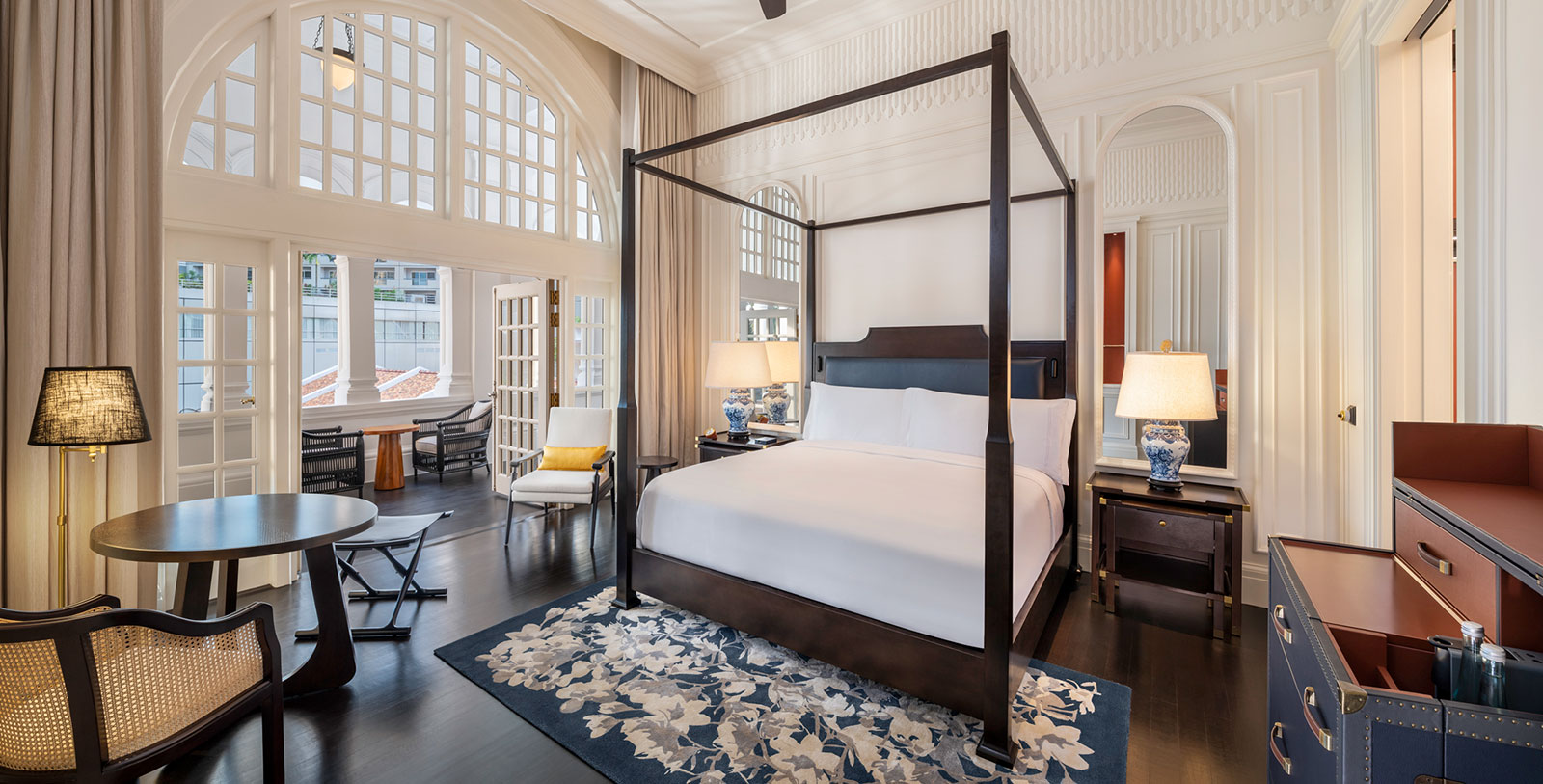 a bedroom with a four poster bed and a chair