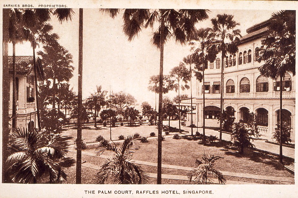 a building with palm trees in front of it