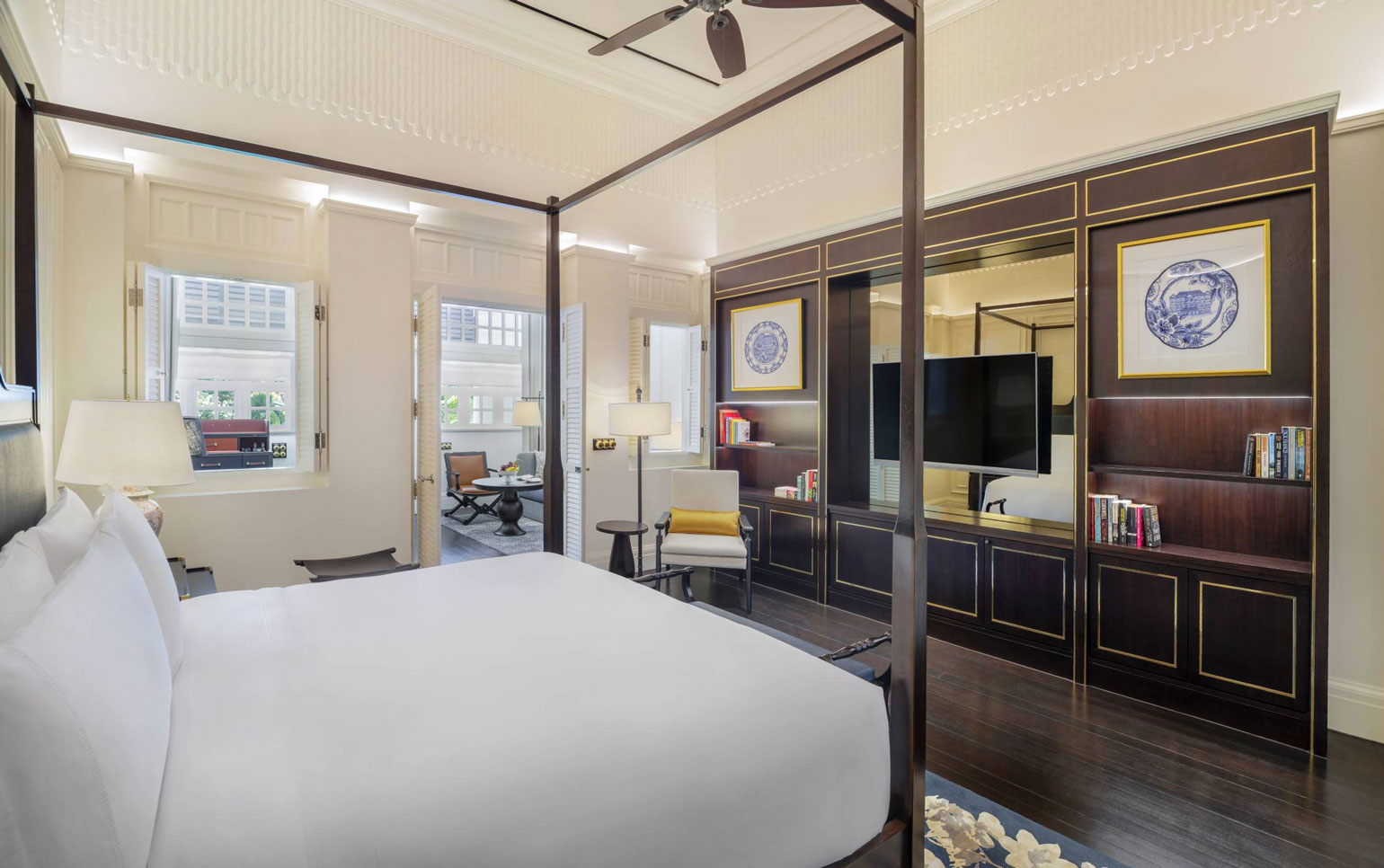 a bedroom with a four poster bed and a television