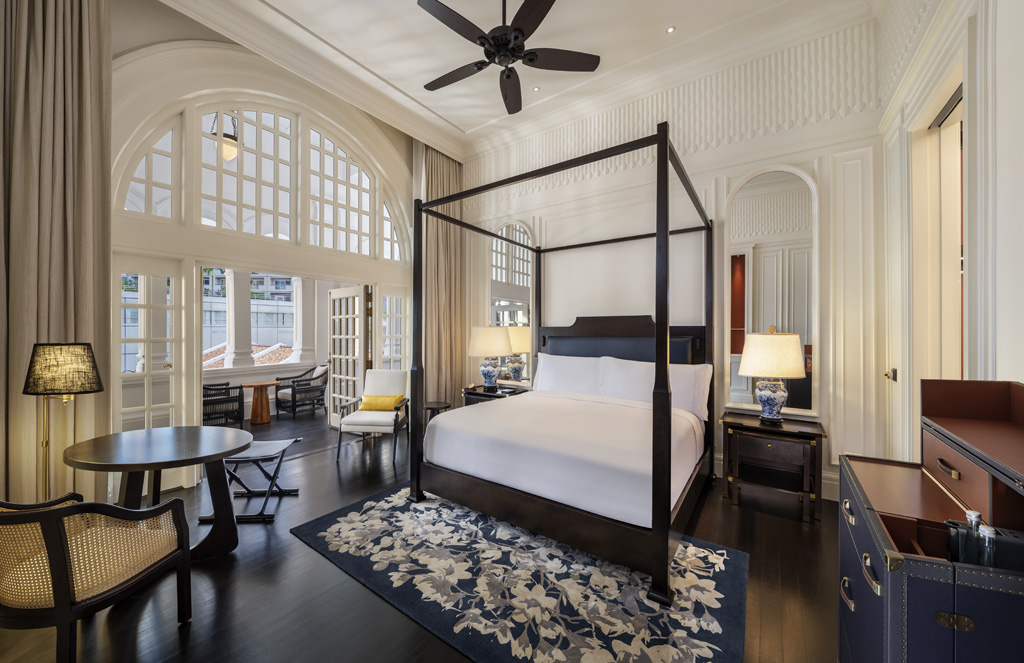 a bedroom with a four poster bed and a table