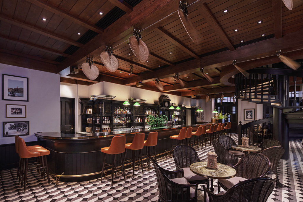 a bar with chairs and tables in a room
