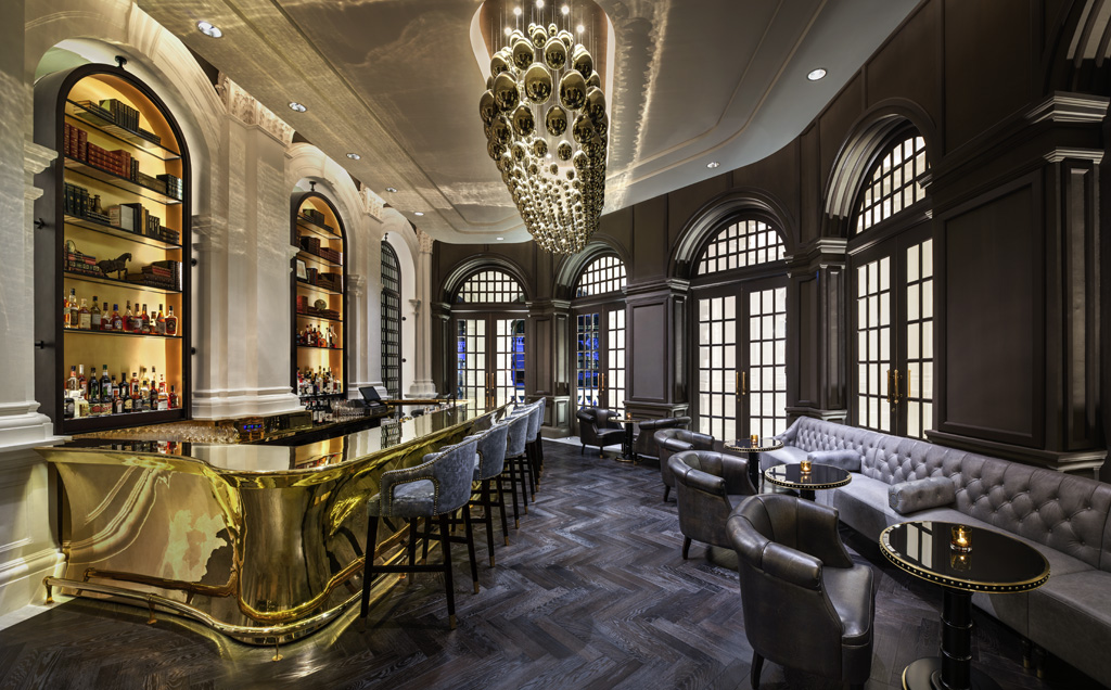 a bar with a chandelier and chairs