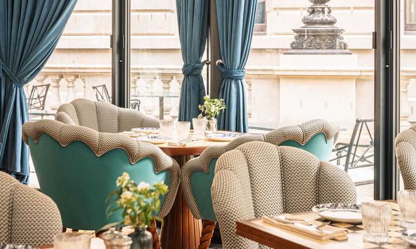 a table with blue chairs and a table with plates and plates
