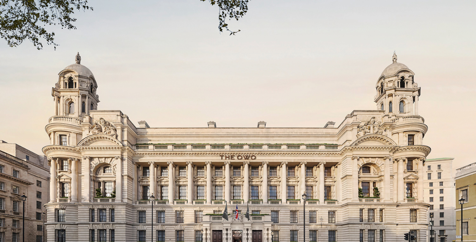 a large white building with columns and a flag