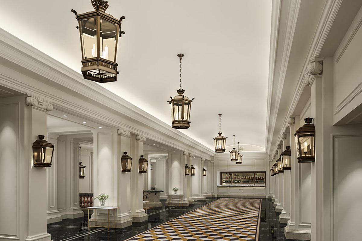 a long hallway with white columns and lamps