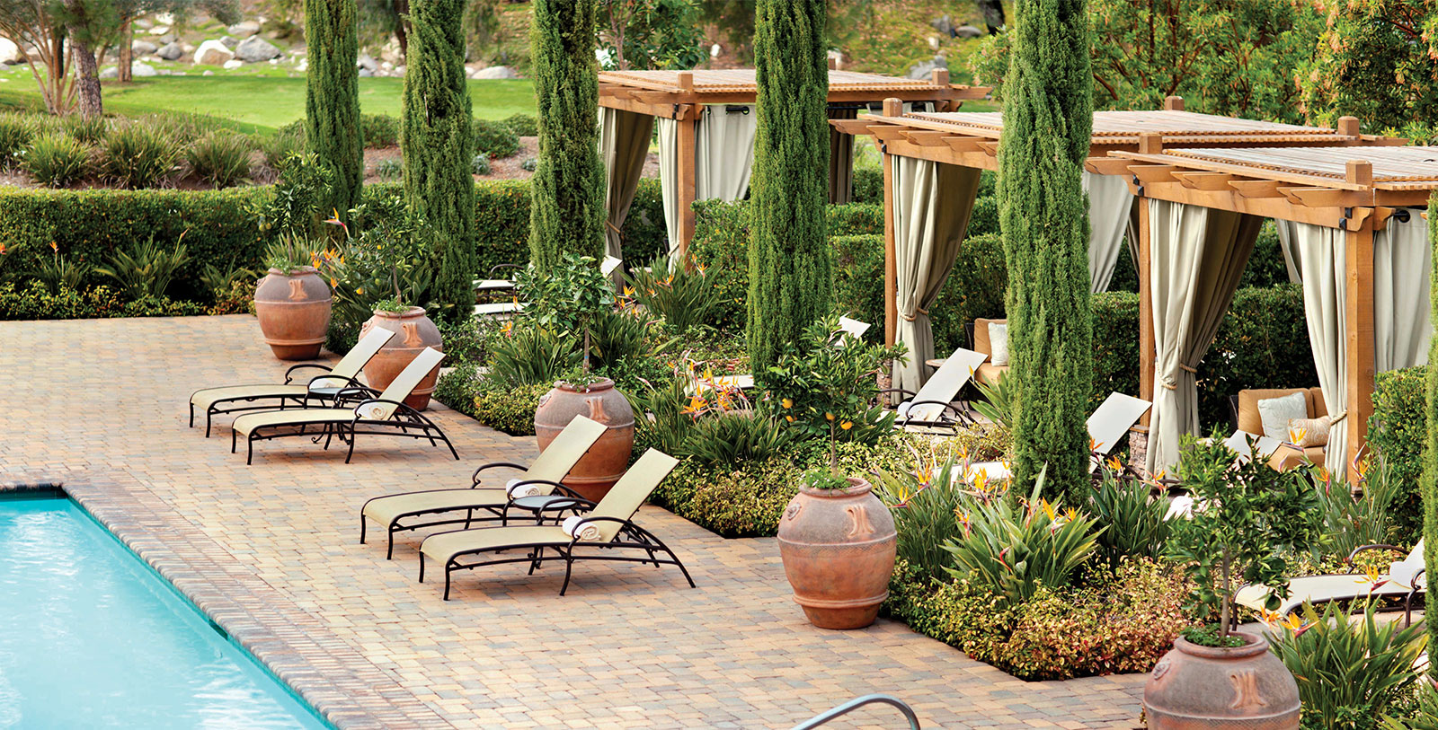 a patio with chairs and plants