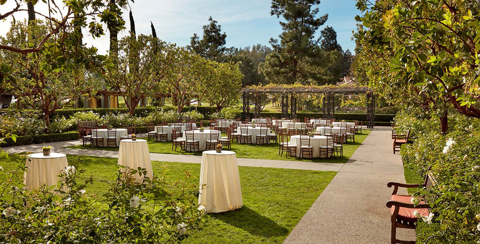 a group of tables and chairs in a garden