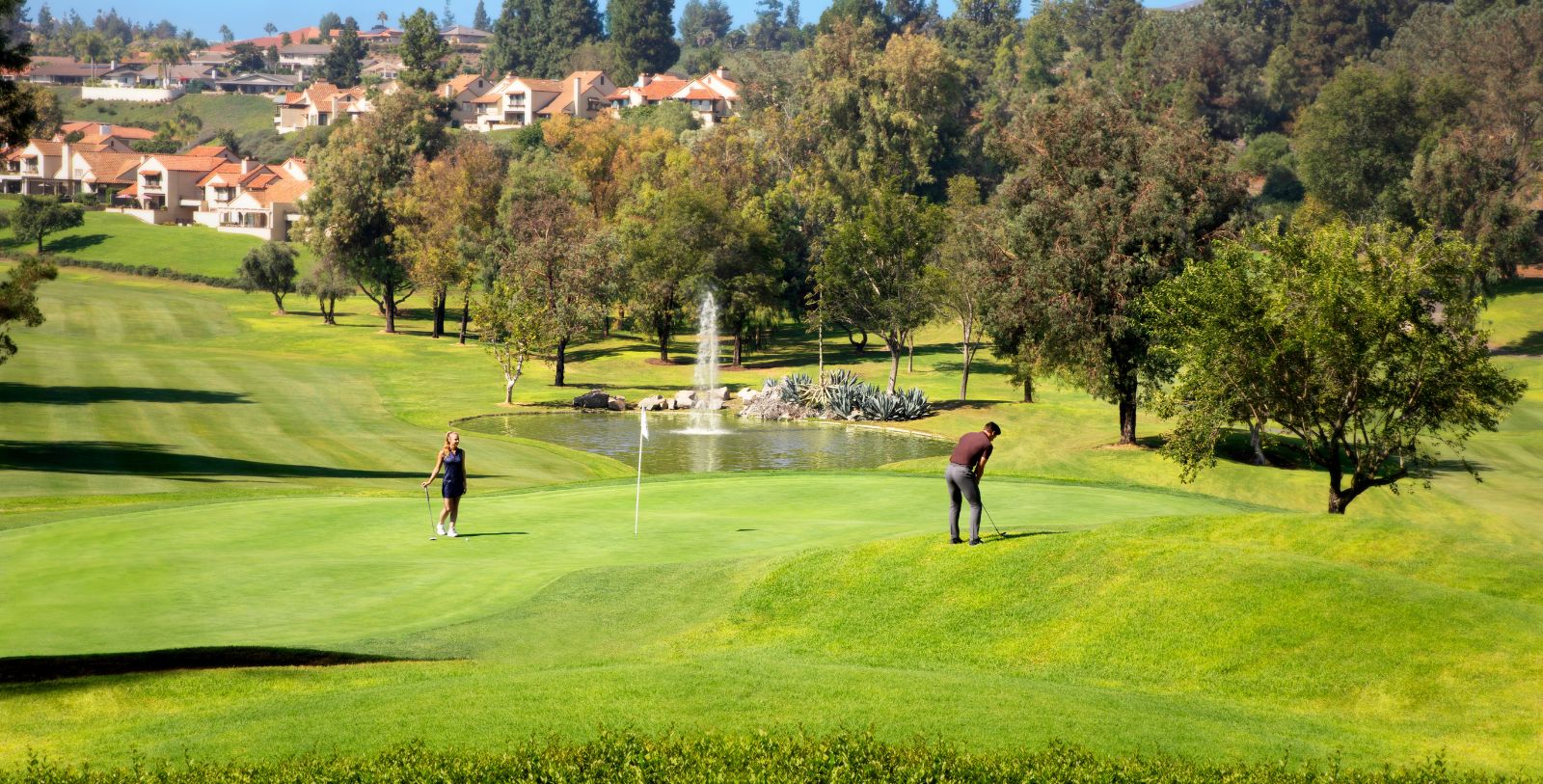 a man and woman playing golf