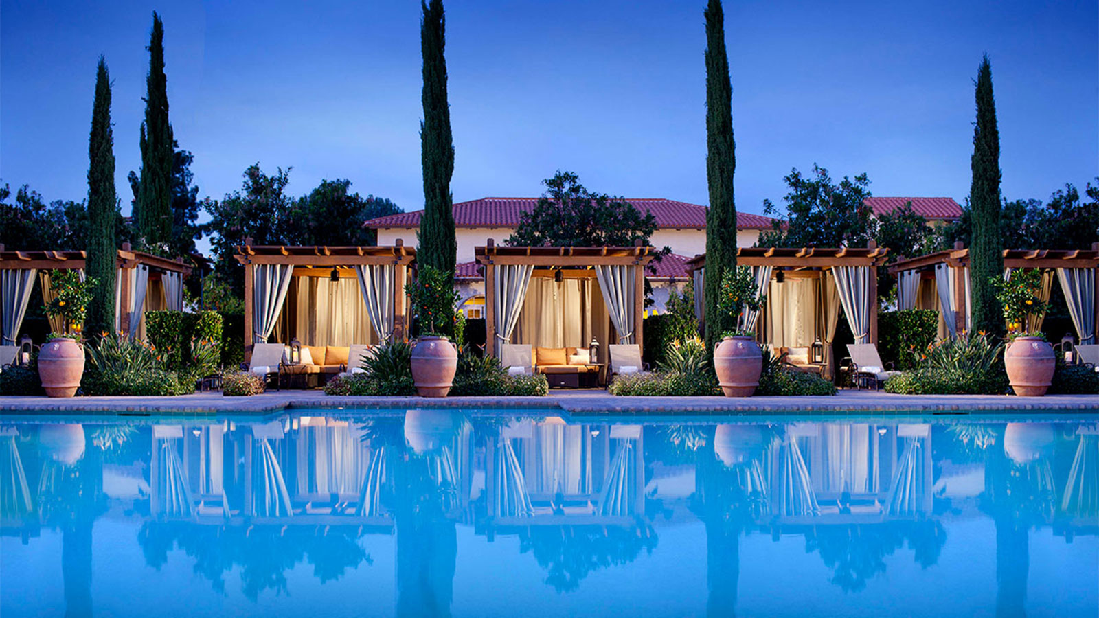 a pool with a gazebo and trees