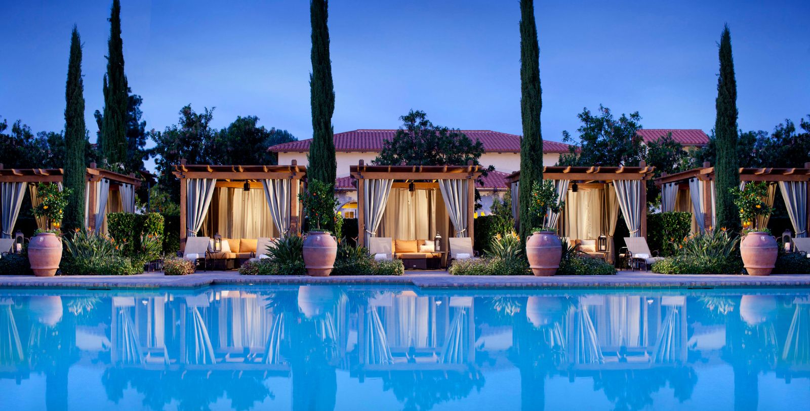 a pool with a gazebo and trees