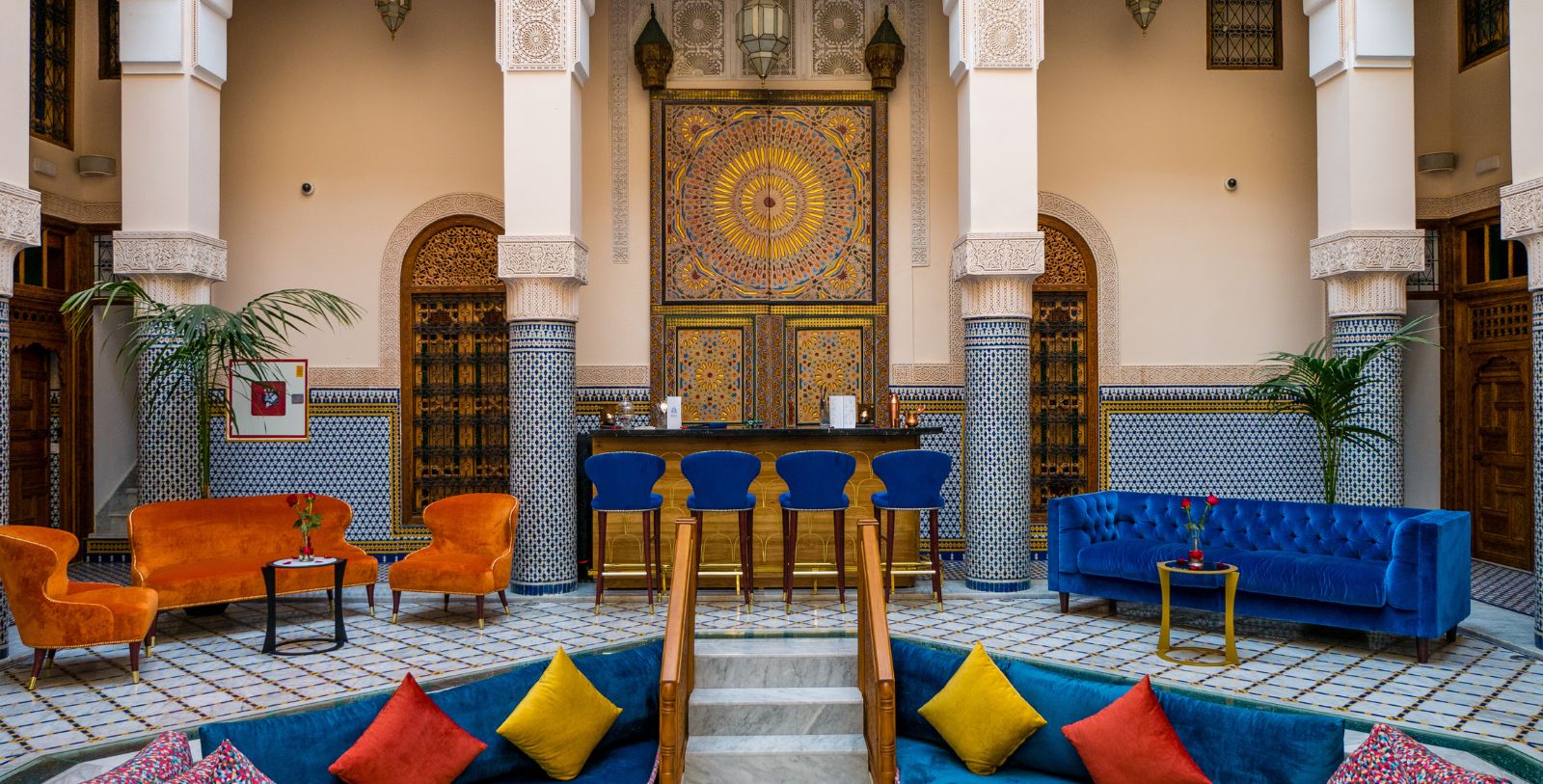 a room with blue couches and chairs