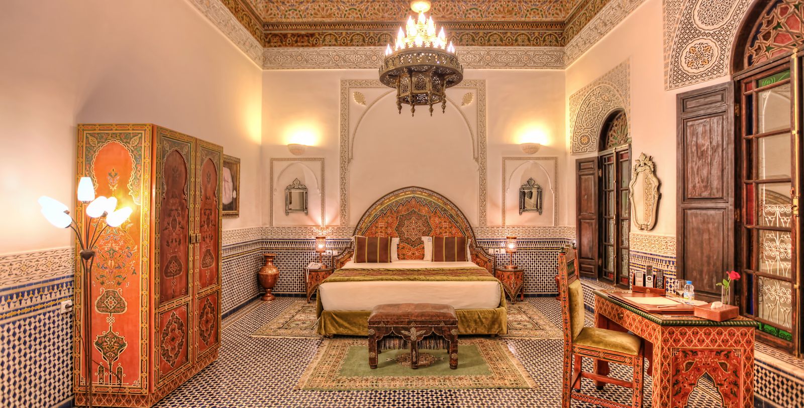 a room with a bed and a chandelier