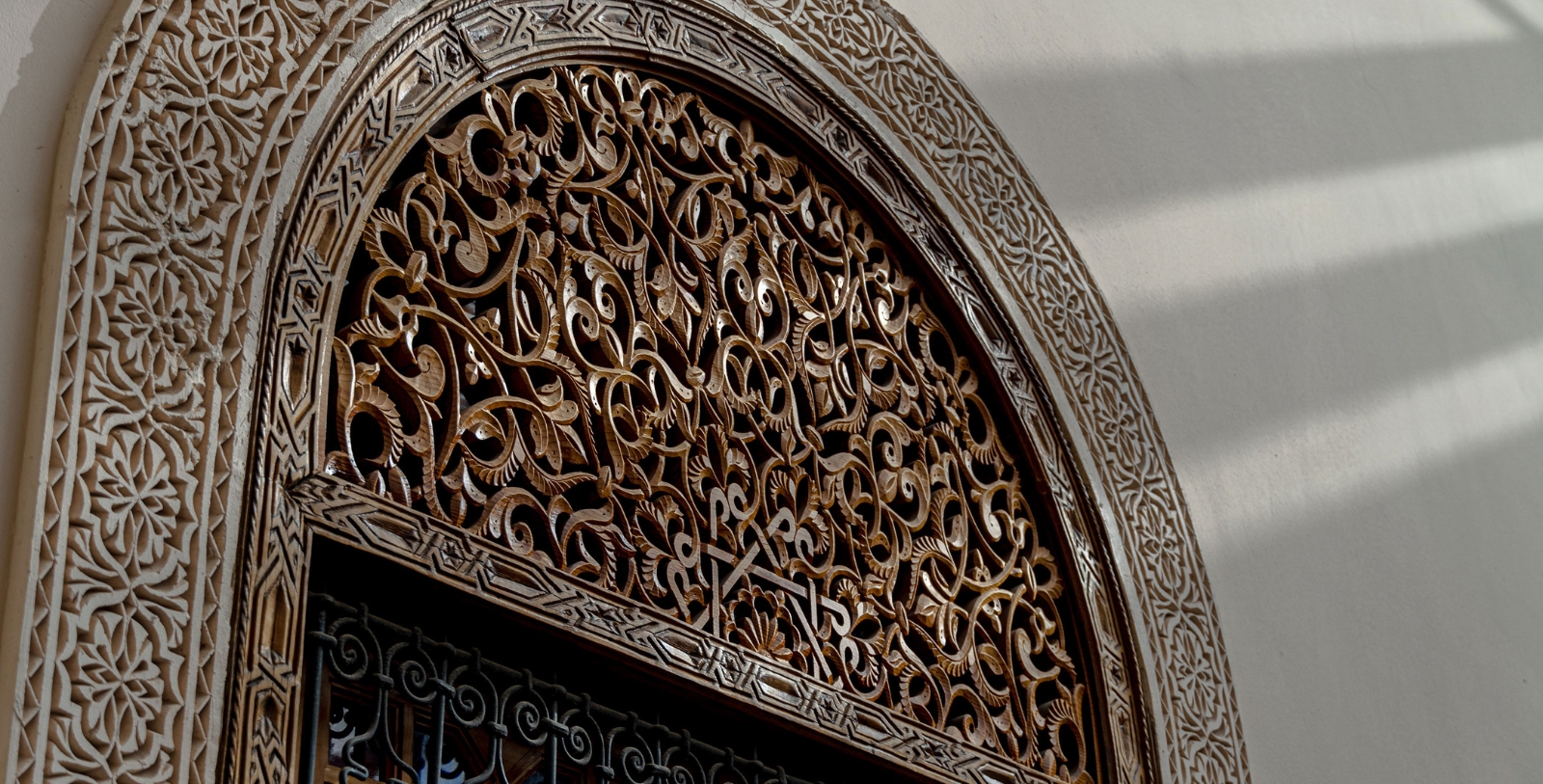 a ornate arch with a metal fence