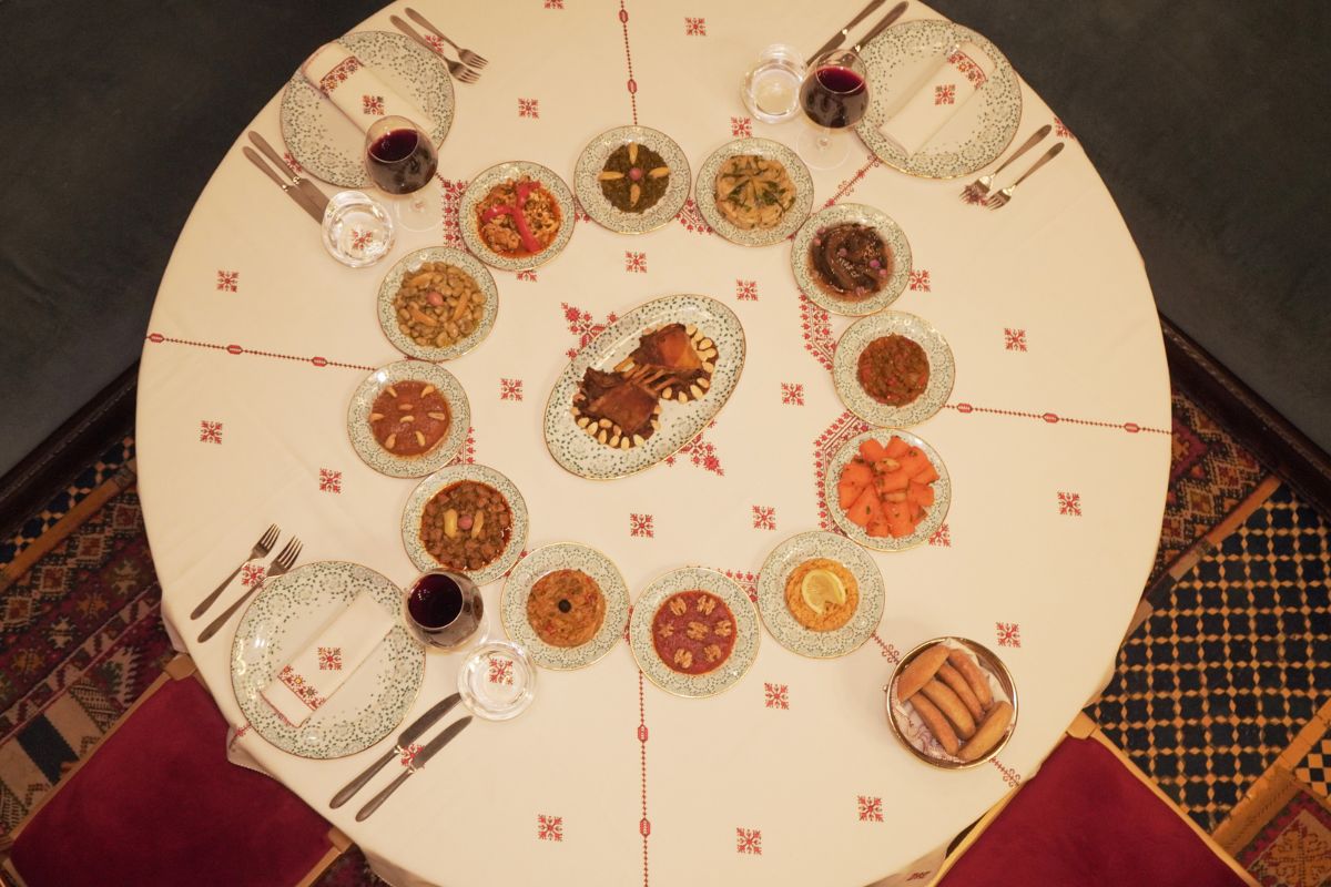 a table with plates of food and glasses