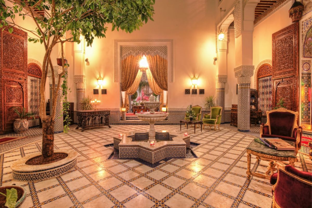 a room with a fountain and a tree