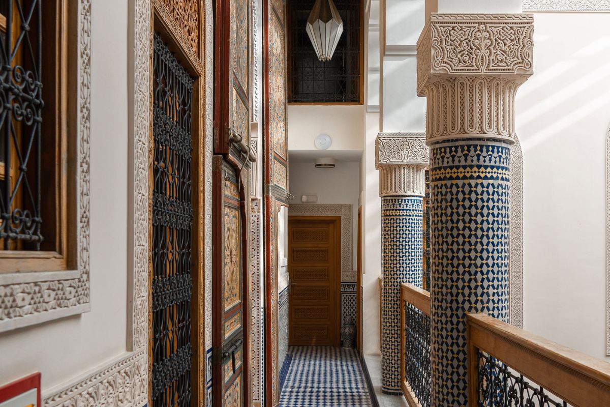 a hallway with ornate pillars and doors