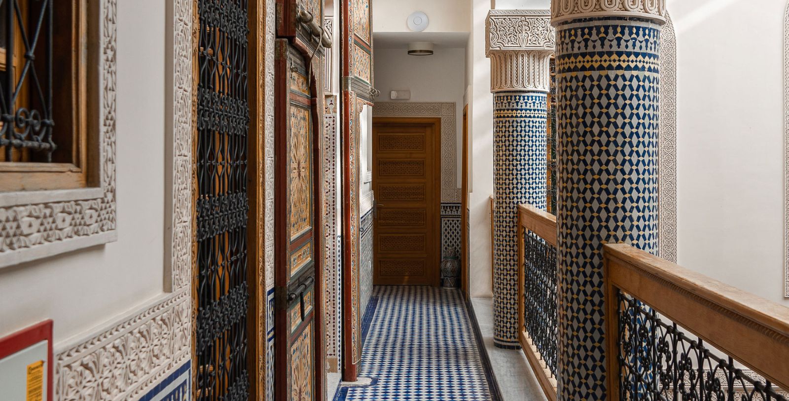 a hallway with ornate doors and columns