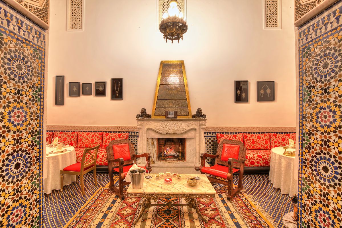 a room with a fireplace and tables