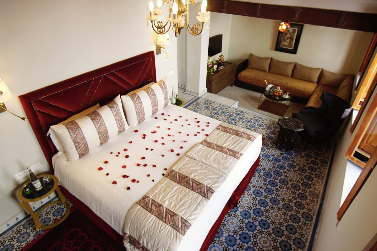 a bed with rose petals on it