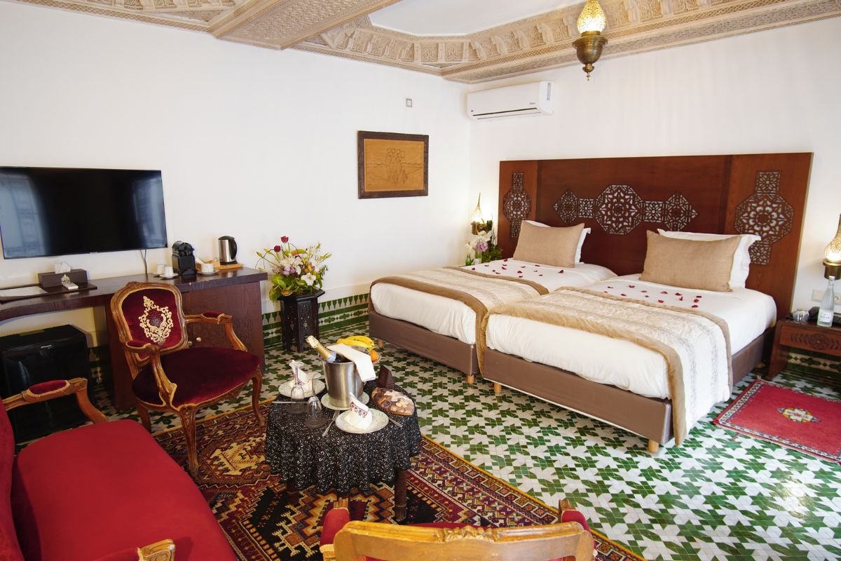 a room with two beds and a table