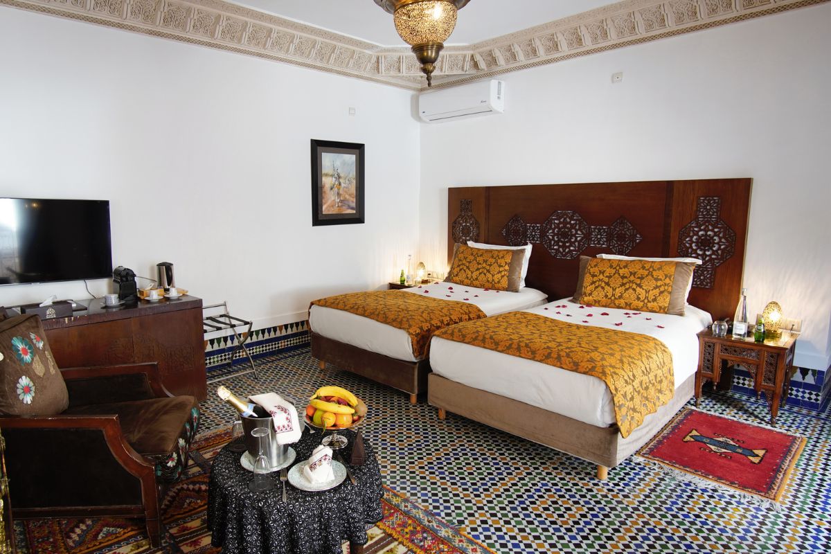 a room with two beds and a table