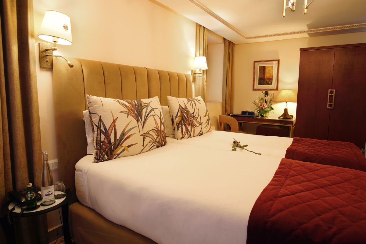 a bed with pillows and a lamp