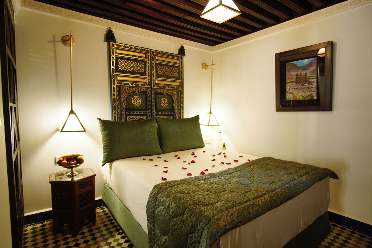 a bed with rose petals on it