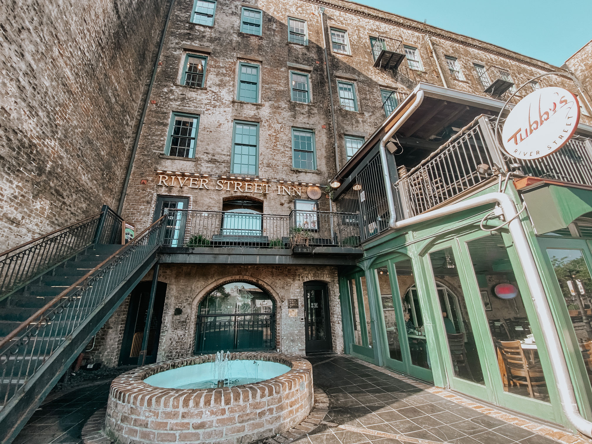 a building with a fountain and stairs