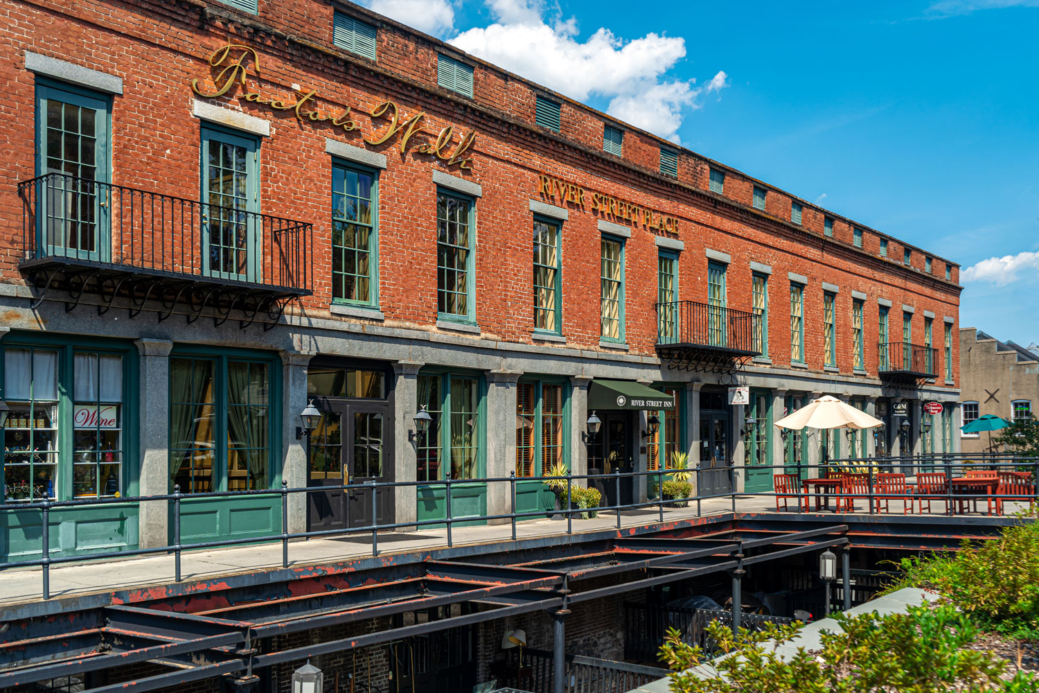 a brick building with a walkway and a patio