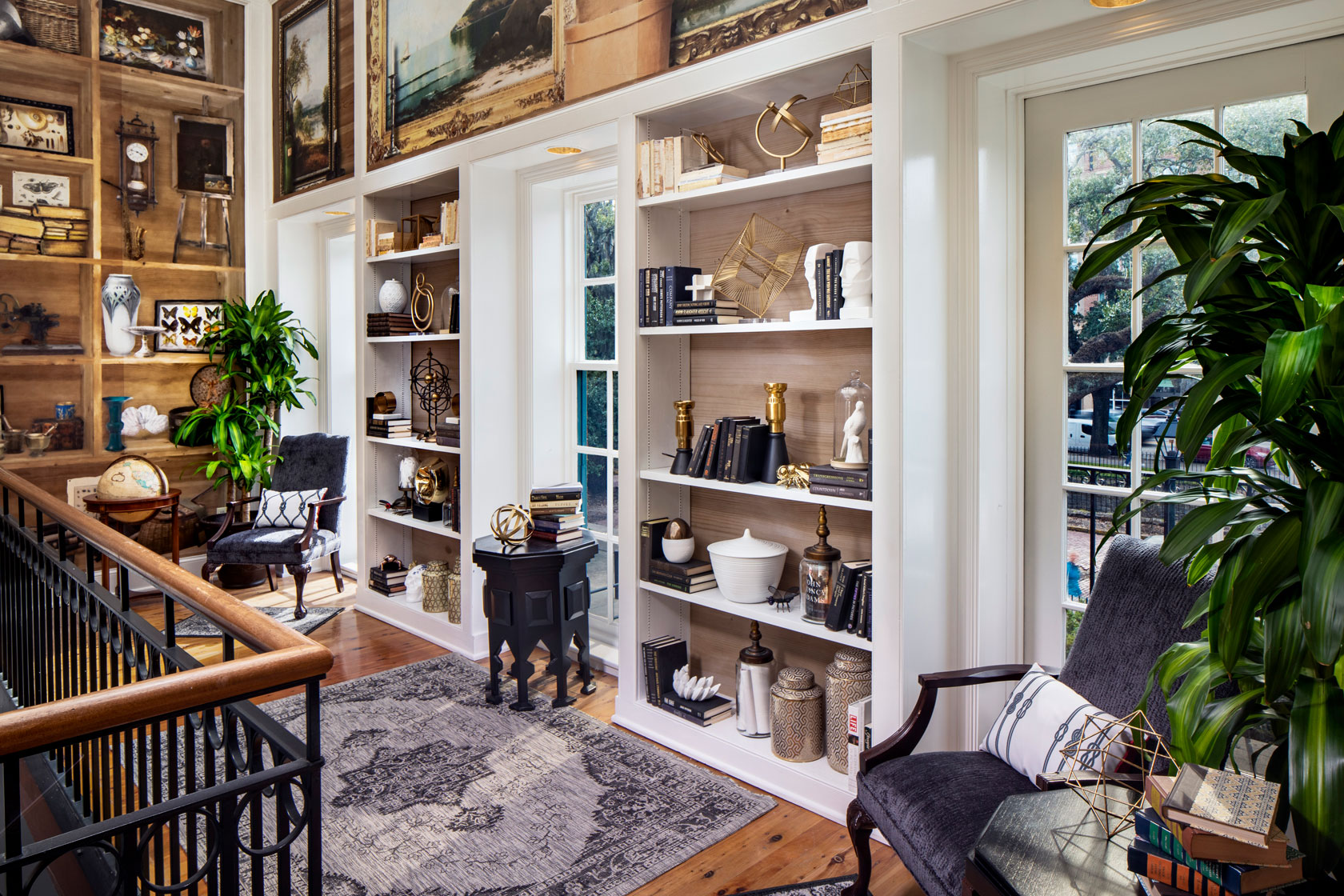 a room with white shelves and a chair