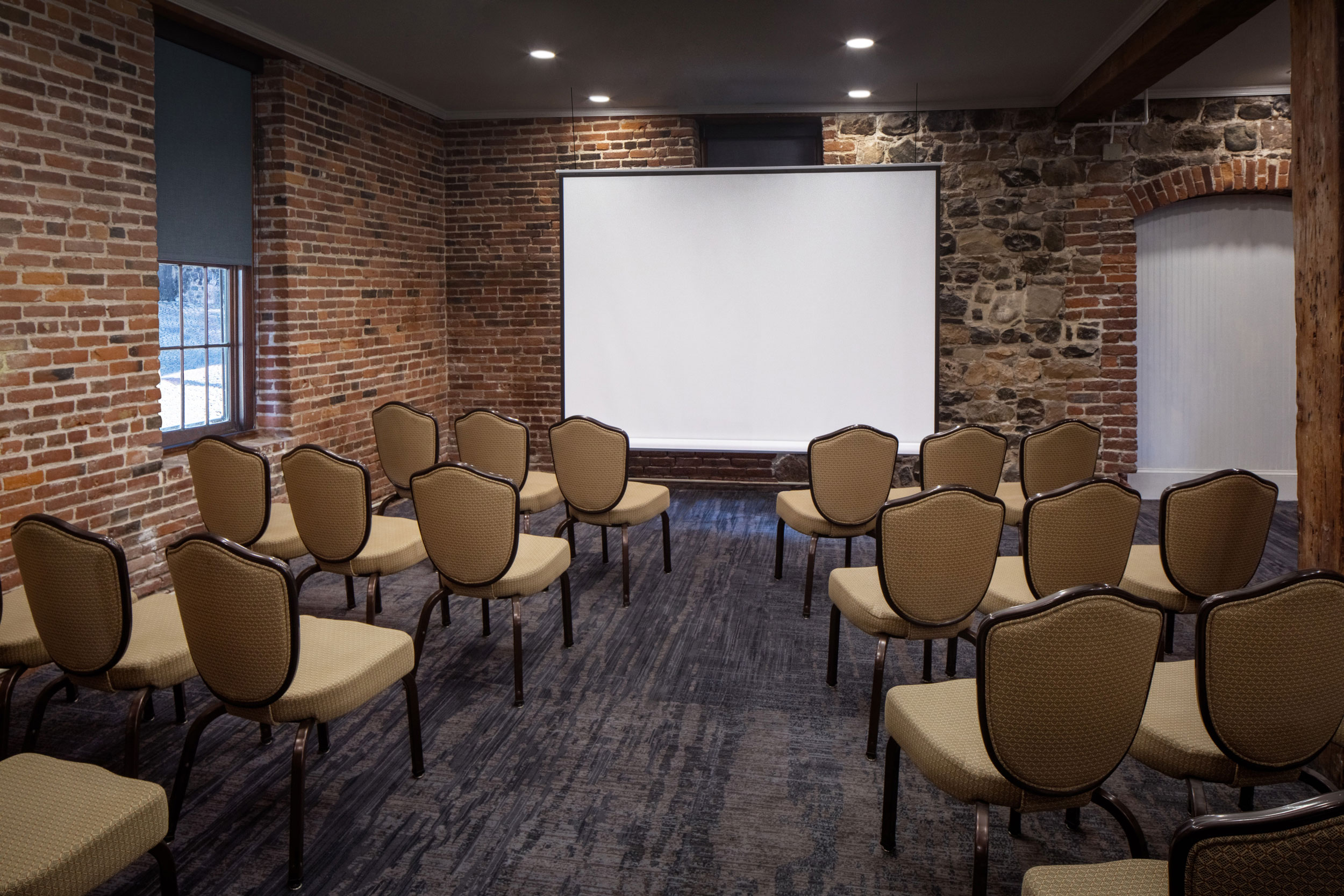 a room with chairs and a projector screen