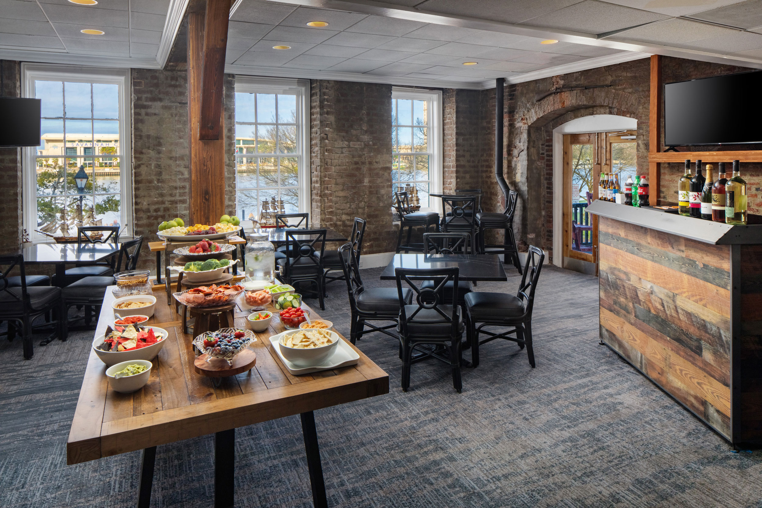 a room with a table of food and chairs