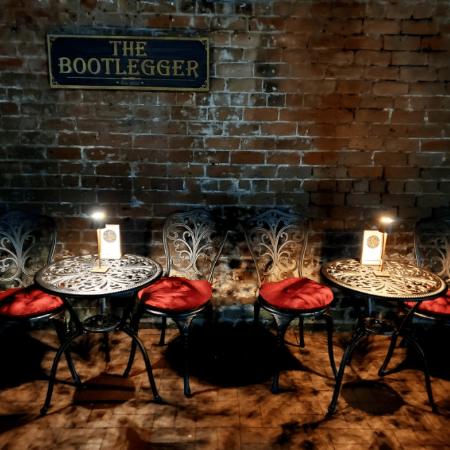 a group of tables and chairs in a room with a brick wall