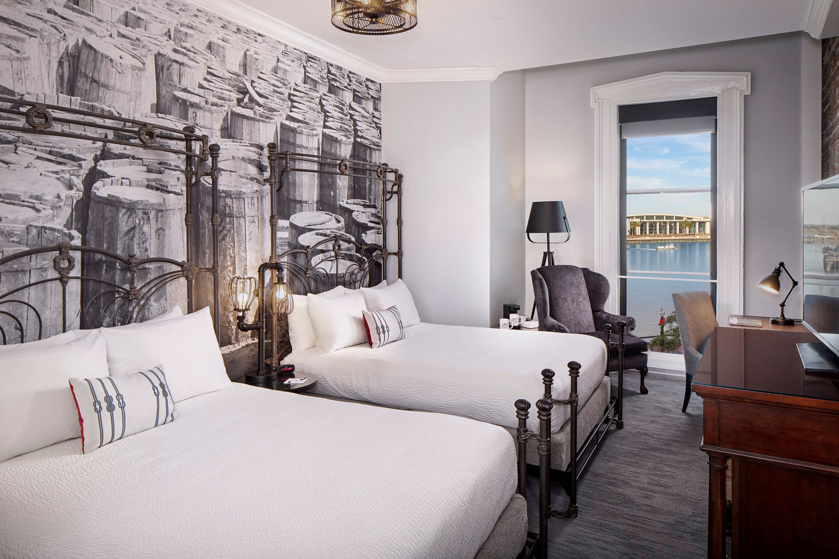a room with two beds and a large window