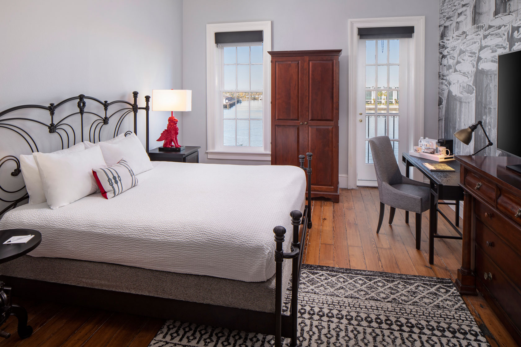 a bedroom with a desk and a bed