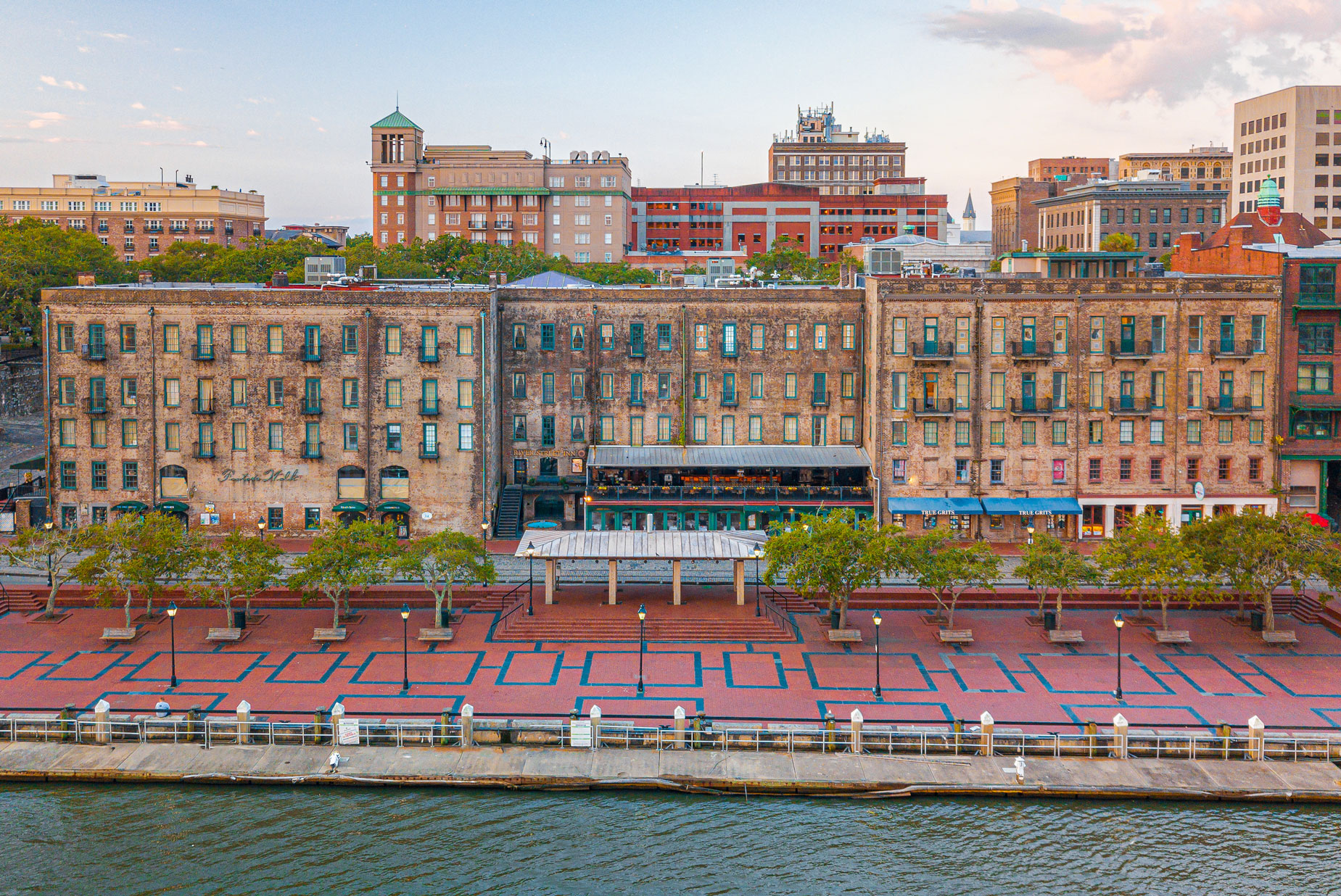 a large brick building next to a body of water