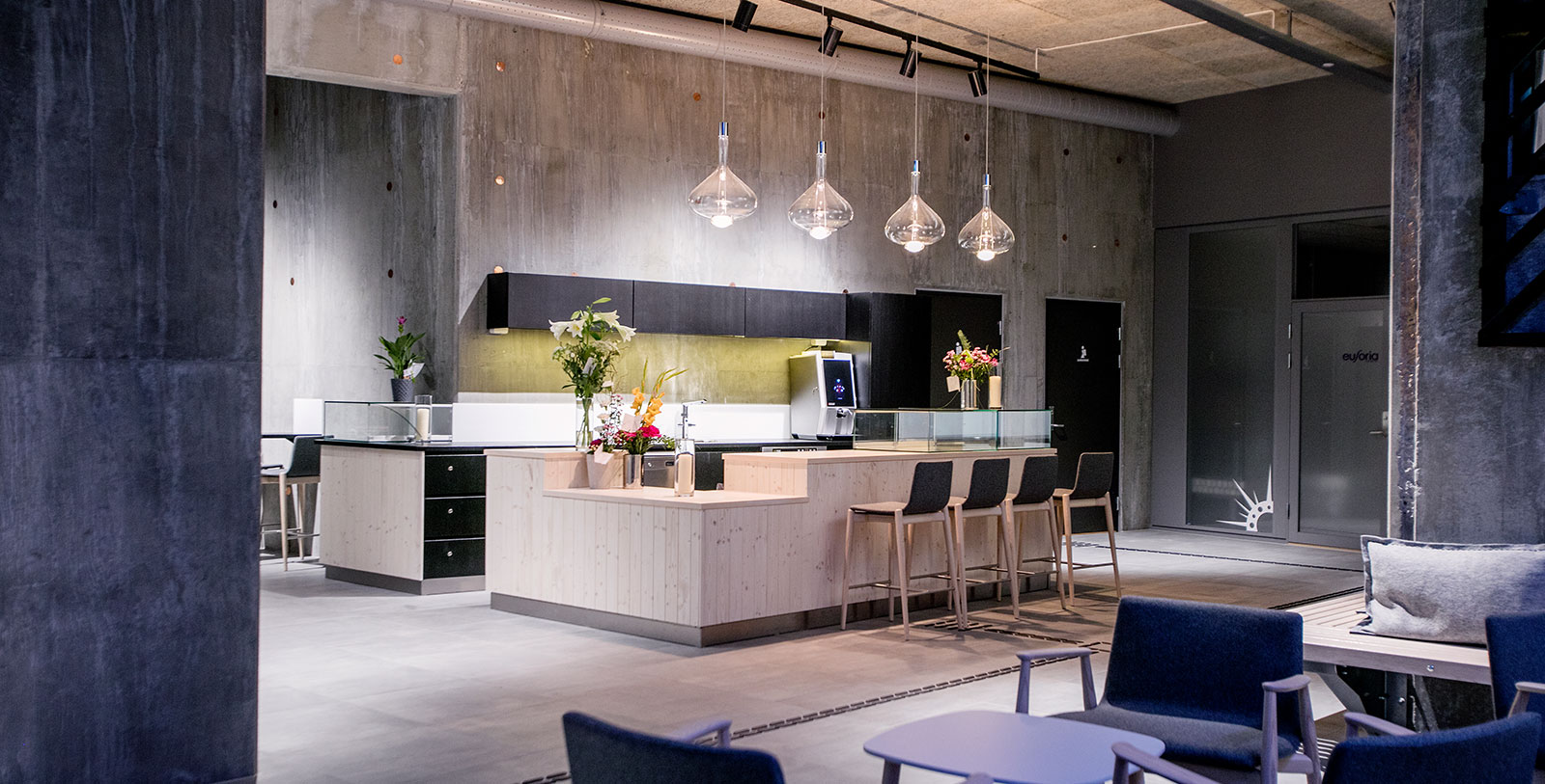 a kitchen with chairs and a counter