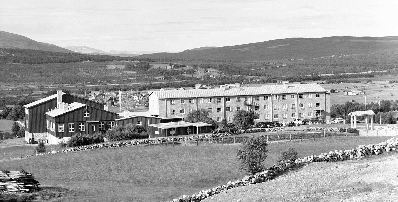 a building with a fence and a field