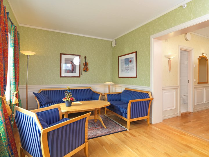 a room with blue couches and a table