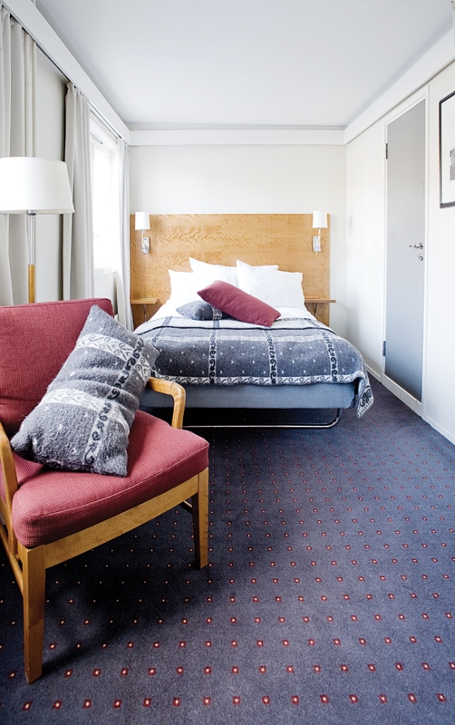 a bedroom with a bed and a chair