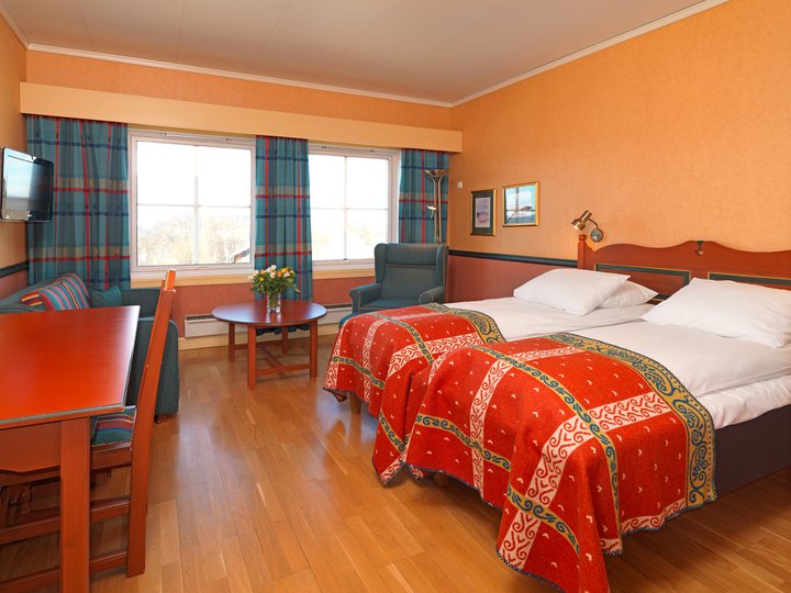 a room with two beds and a table